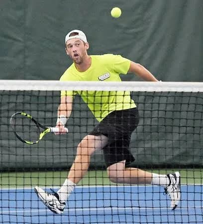 Sam Sweeney closing in at the net on an indoor court